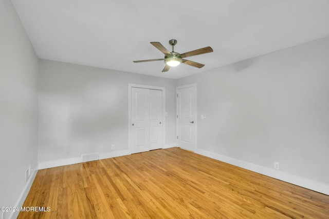 empty room featuring hardwood / wood-style flooring and ceiling fan