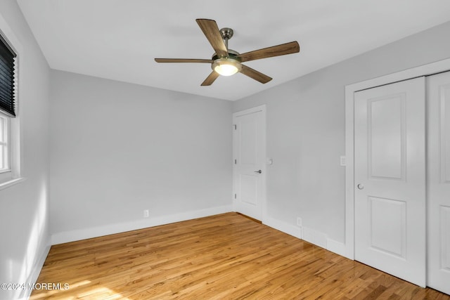 unfurnished bedroom with light wood-type flooring, a closet, and ceiling fan