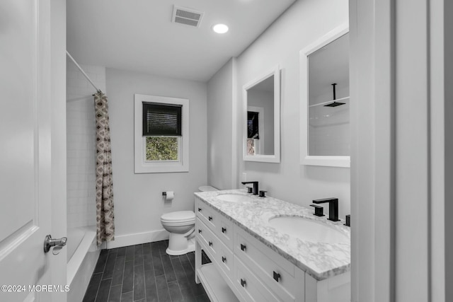 full bathroom with shower / tub combo, vanity, and toilet