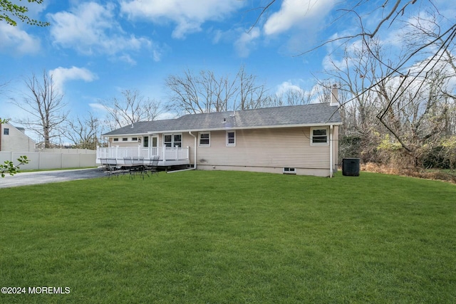 back of house featuring a lawn, central AC unit, and a deck