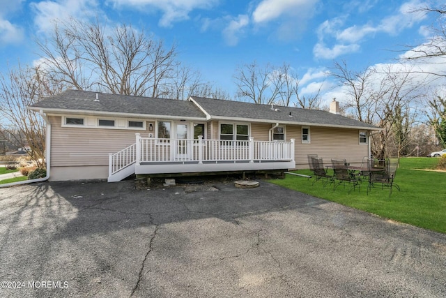 back of house featuring a yard and a deck