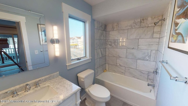 full bathroom with vanity, tiled shower / bath combo, and toilet