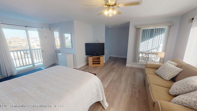 bedroom featuring ceiling fan, access to outside, and light hardwood / wood-style flooring