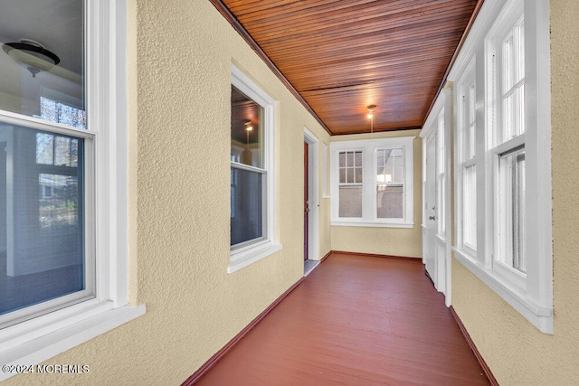 unfurnished sunroom with wooden ceiling