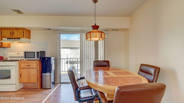 dining space featuring light wood-type flooring