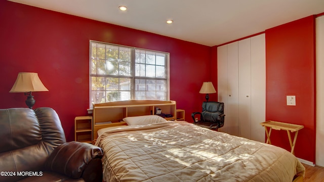 bedroom with hardwood / wood-style flooring