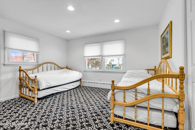 carpeted bedroom with a baseboard heating unit