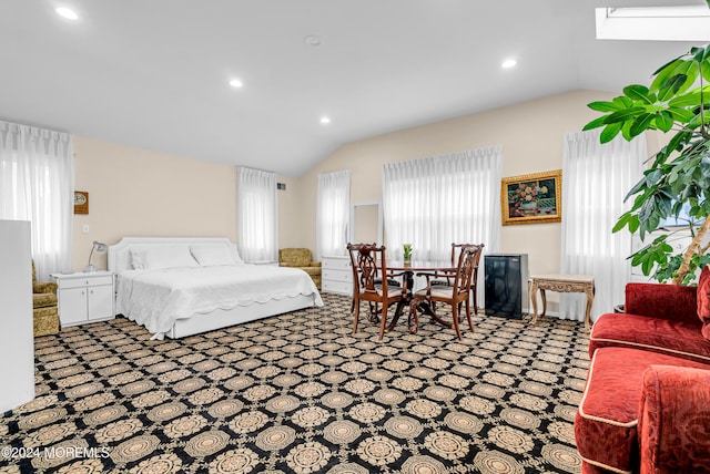 carpeted bedroom with lofted ceiling