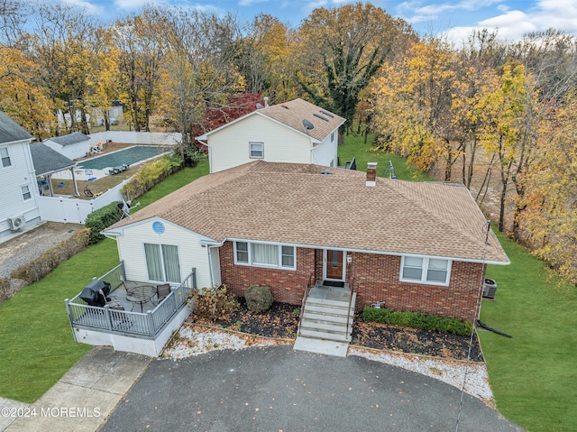 view of front of house featuring a front yard and cooling unit