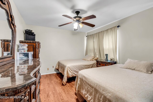 bedroom with ceiling fan and light hardwood / wood-style floors