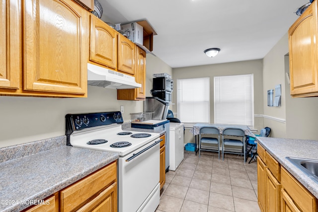 kitchen featuring white electric range oven and light tile patterned floors