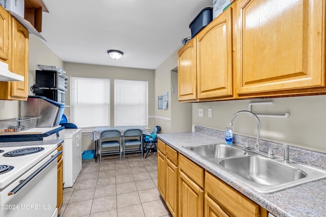 kitchen featuring washer and clothes dryer, white electric range oven, light tile patterned flooring, and sink