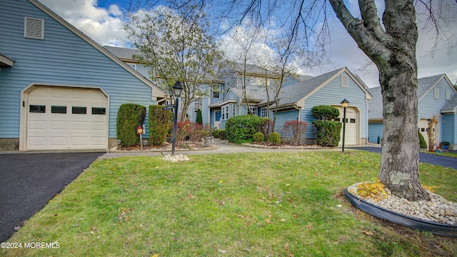 view of front of home with a front yard and a garage