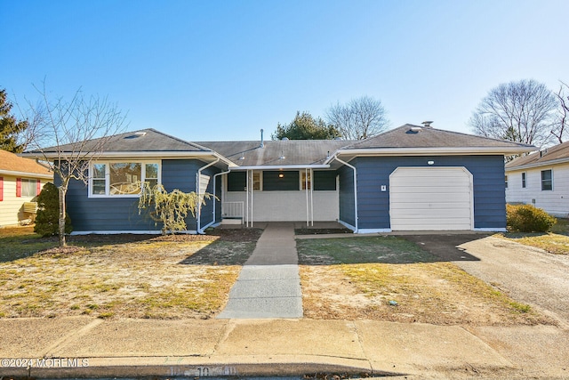 single story home with a porch and a garage