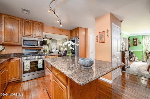 994 Hyson Rd, Jackson, NJ 08527 - kitchen with stainless steel appliances, a center island, light wood-type flooring, and dark stone countertops