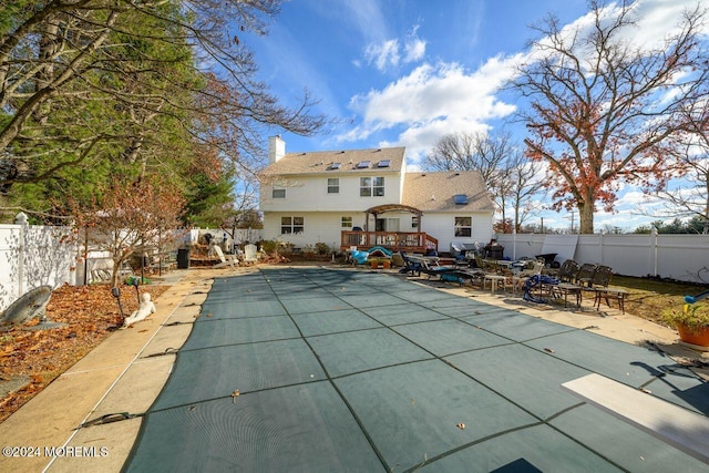 994 Hyson Rd, Jackson, NJ 08527 - rear view of house with a fenced backyard, a wooden deck, a chimney, and a patio area