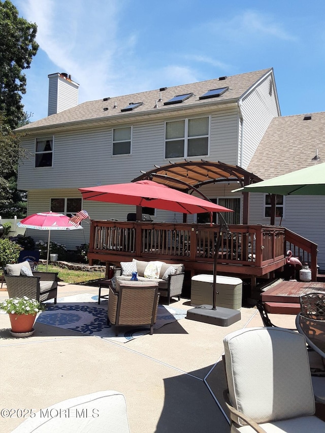 994 Hyson Rd, Jackson, NJ 08527 - back of house with an outdoor living space, a patio area, a deck, a chimney, and roof with shingles
