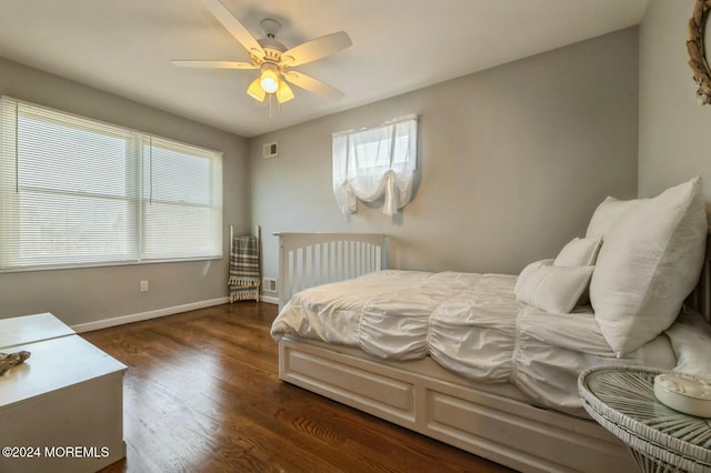 bedroom featuring multiple windows, ceiling fan, and dark wood-type flooring