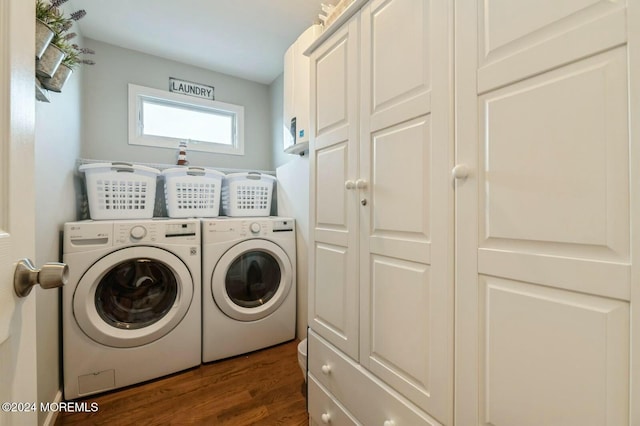 laundry room with cabinets, washer and dryer, and dark hardwood / wood-style floors