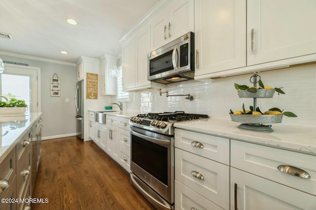 kitchen featuring a wealth of natural light, dark wood-type flooring, white cabinets, and stainless steel appliances