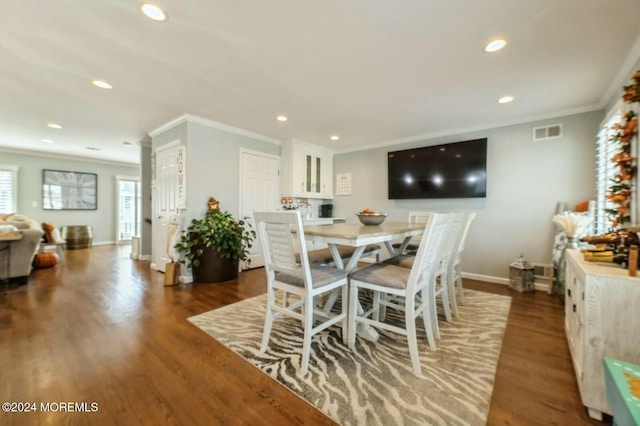 dining room featuring dark hardwood / wood-style flooring and crown molding