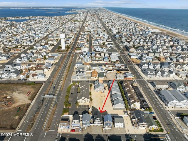 bird's eye view with a water view and a beach view