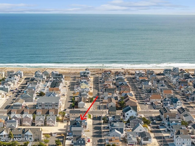 bird's eye view featuring a water view and a beach view