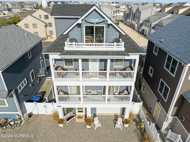 back of property with a balcony and cooling unit