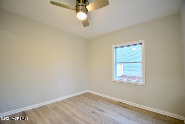 spare room featuring light hardwood / wood-style floors and ceiling fan