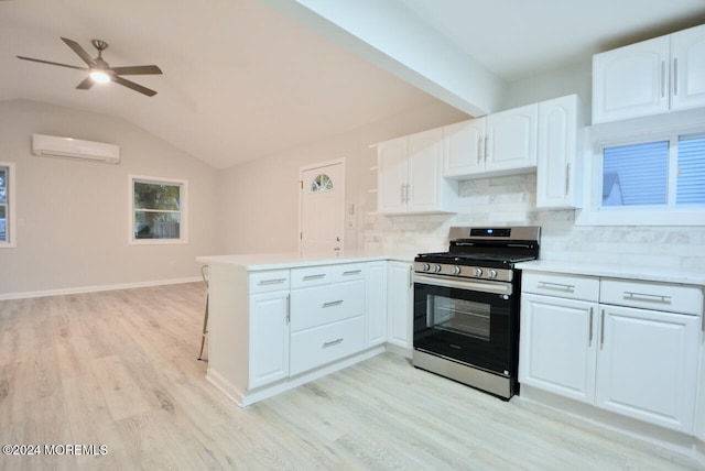 kitchen featuring white cabinetry, stainless steel gas range, kitchen peninsula, light hardwood / wood-style floors, and decorative backsplash