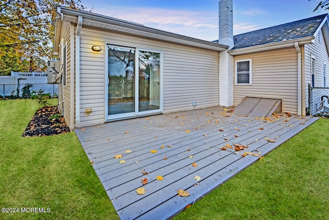 wooden terrace featuring a yard