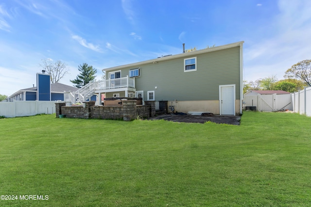 back of house with a lawn