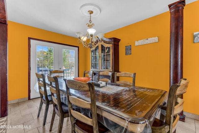 tiled dining space featuring a chandelier, french doors, and ornate columns