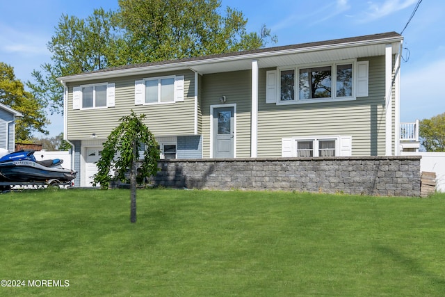 split foyer home with a garage and a front lawn