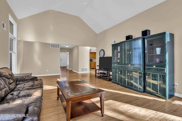 living room featuring hardwood / wood-style floors and high vaulted ceiling