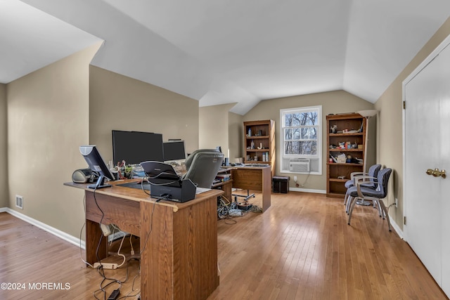 office featuring cooling unit, lofted ceiling, and light hardwood / wood-style flooring