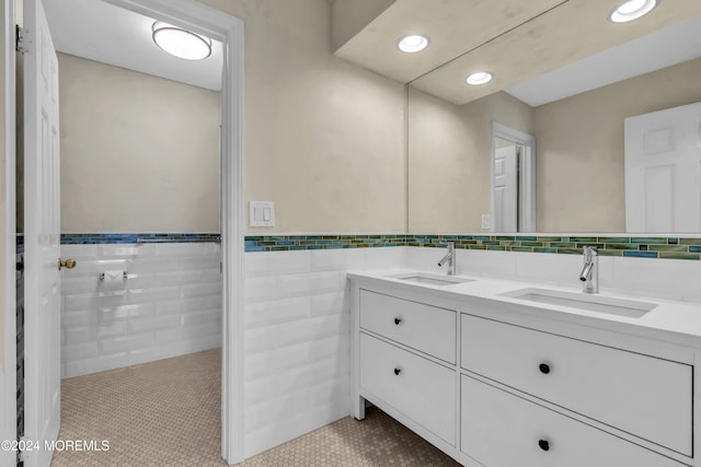 bathroom with tile patterned flooring, vanity, and tile walls