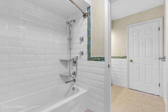 bathroom with tile patterned floors and tiled shower / bath