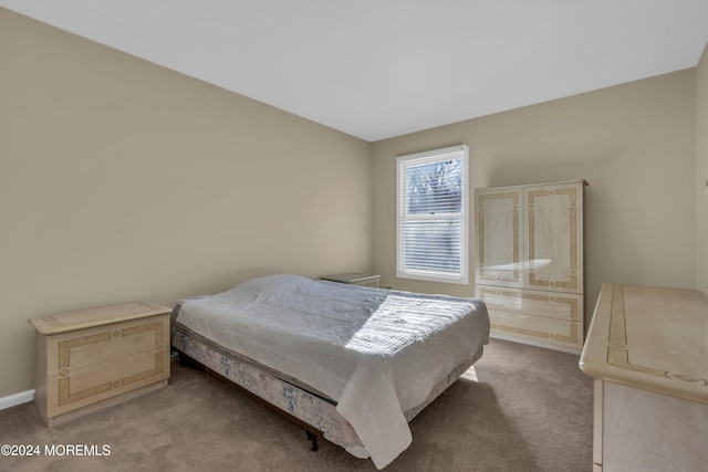 bedroom featuring light colored carpet