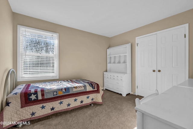 bedroom with carpet and a closet