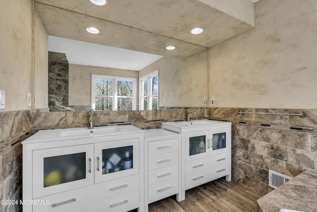 kitchen featuring tile walls, sink, white cabinets, and dark hardwood / wood-style floors