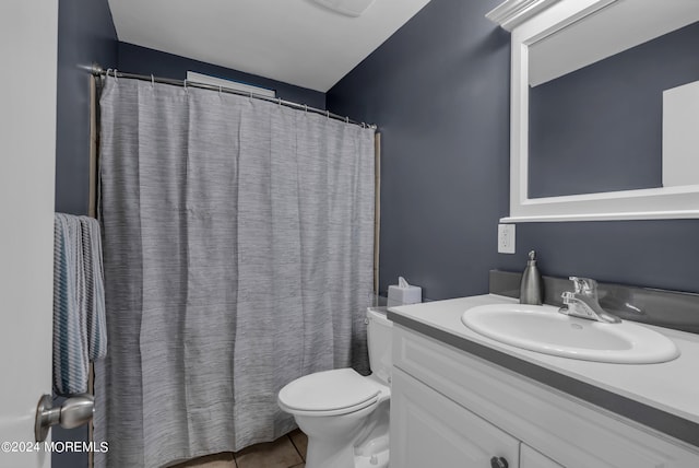 bathroom featuring tile patterned flooring, vanity, and toilet