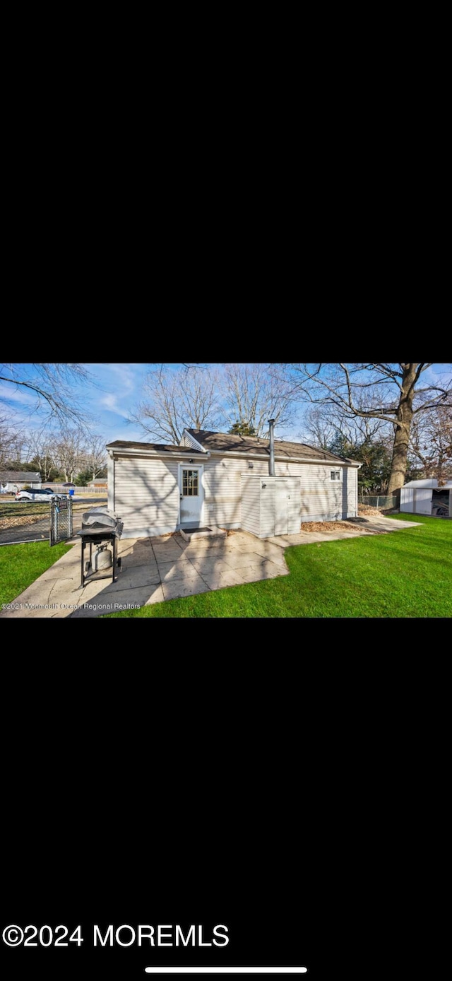 exterior space featuring a patio area and a front lawn