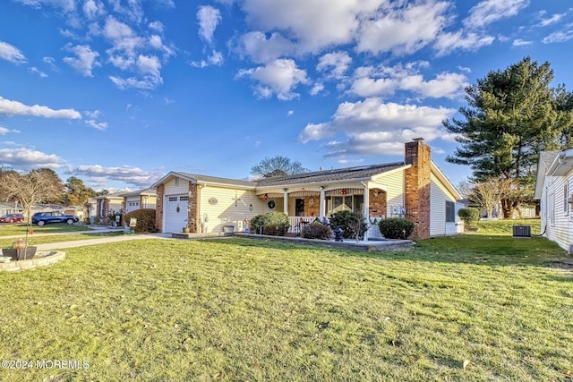 ranch-style home with a porch, cooling unit, a front yard, and a garage