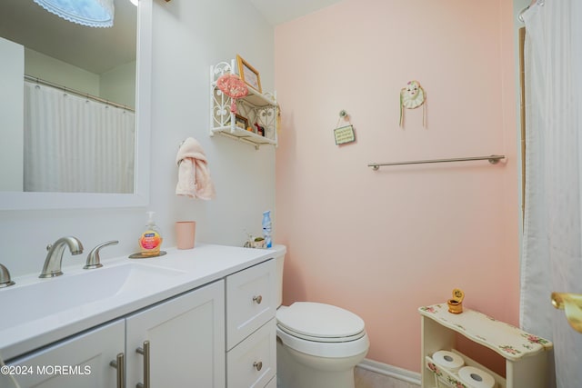 bathroom with toilet and vanity