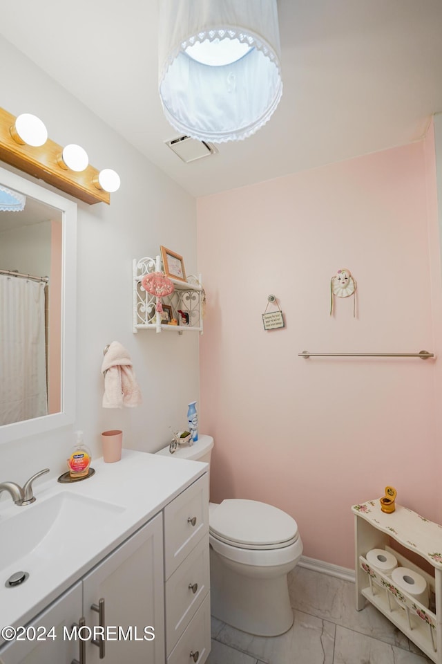 bathroom with vanity and toilet