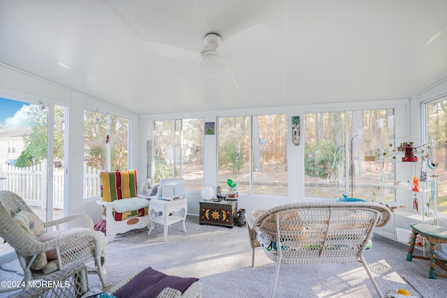 sunroom with a wealth of natural light, ceiling fan, and vaulted ceiling