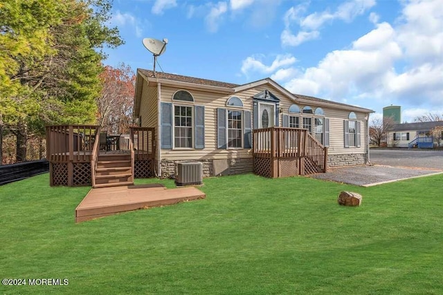 back of house with a wooden deck, a yard, and central AC unit