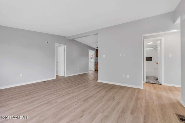 unfurnished room with light wood-type flooring