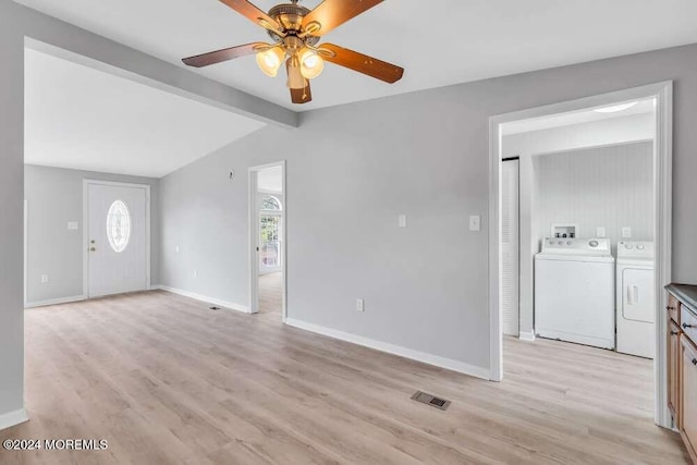 interior space featuring vaulted ceiling with beams, ceiling fan, light wood-type flooring, and washing machine and clothes dryer